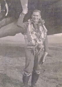 Air crewman in front of military plane