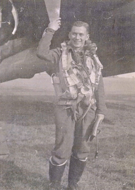 Air crewman in front of military plane