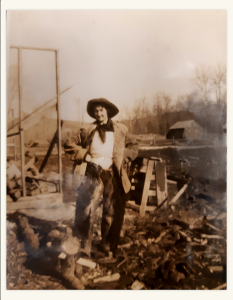 Cowgirl standing in wood pile