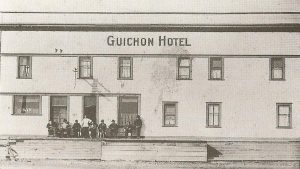Group in front of wooden hotel
