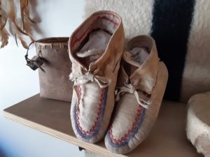 Moccasins and basket on shelf