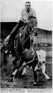 Cowboy on horseback roping a calf