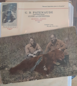 Two men with bear over letterhead