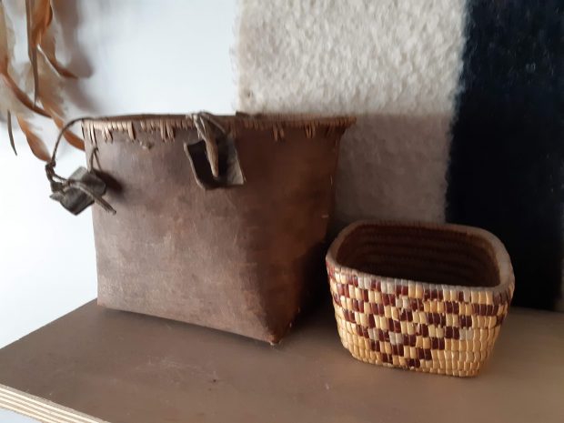 Two first Nations baskets on a shelf