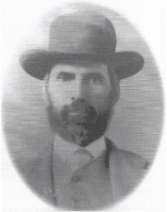 Head and shoulders photo of man wearing hat