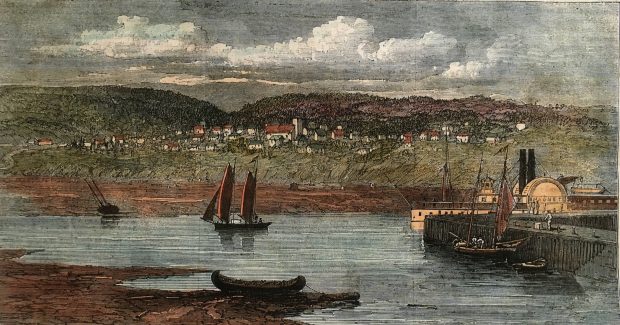 Coloured lithograph of a river scene that features a steamboat at a wharf, a sailboat in the river, a tethered canoe on shore, and a settlement in the background with a church and several houses scattered across the side of a hill.