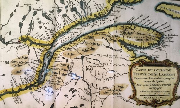 A colour photo of a map depicting the gulf of the Saint Lawrence, the Gaspé region, and the length of the river itself almost to Quebec City. The land surrounding the river and gulf has lakes and smaller rivers drawn in also.