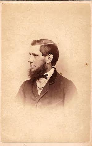 Portrait of man with bushy beard in formal attire