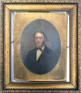 Portrait painted on wooden board of man in formal attire