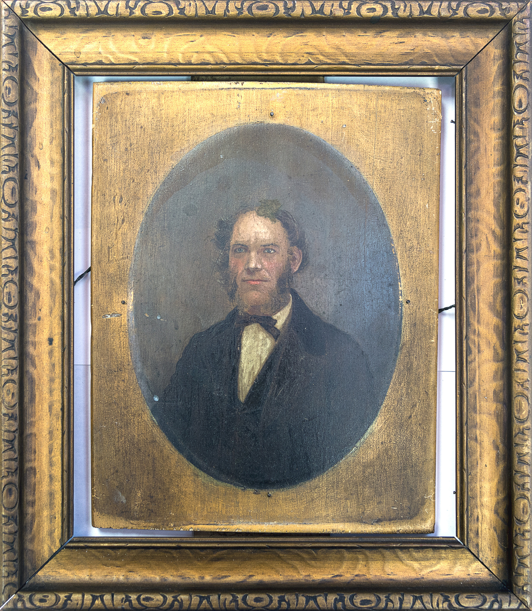 Portrait painted on wooden board of man in formal attire
