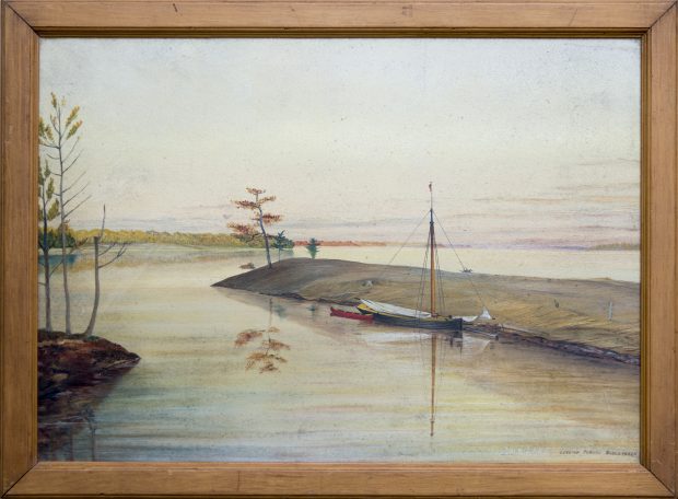Lake scene looking out from shore with sailboat and canoe