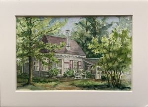 Image of cottage surrounded by trees