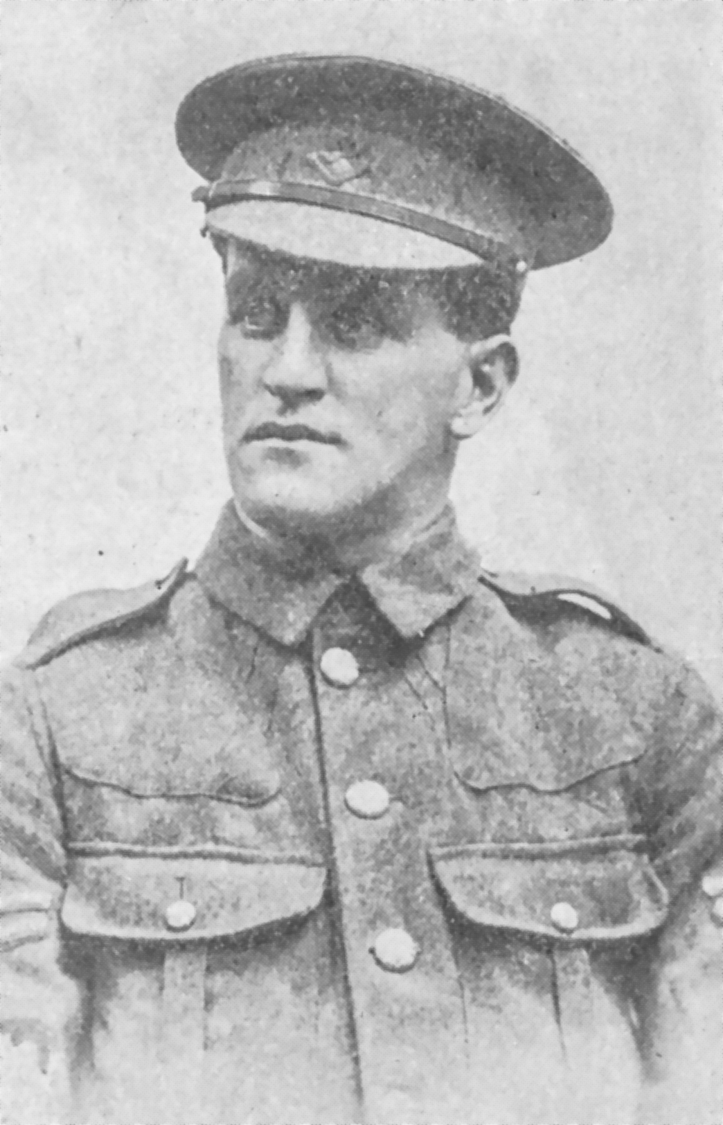 Black and white archival photograph of a man in a uniform wearing a peaked cap.