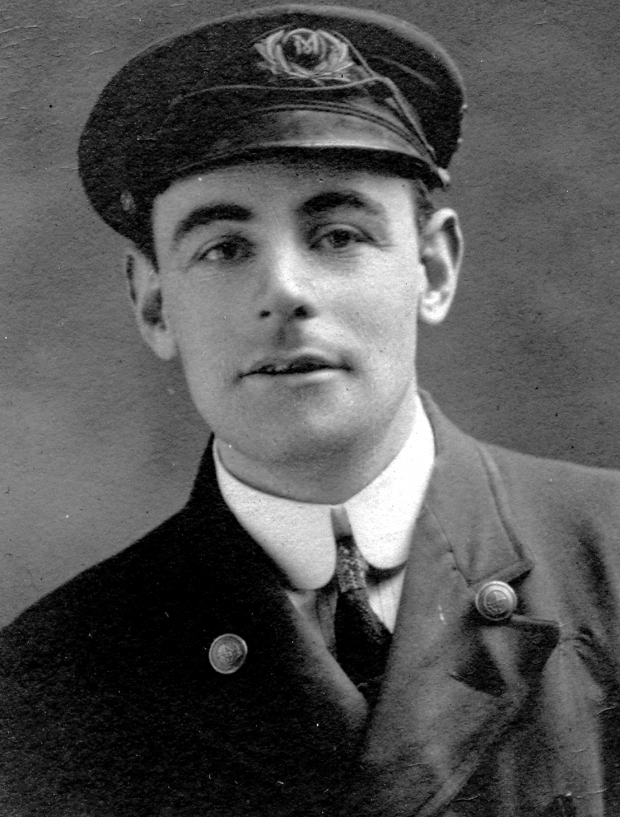 Black and white archival photograph of a man in uniform wearing a peaked cap.