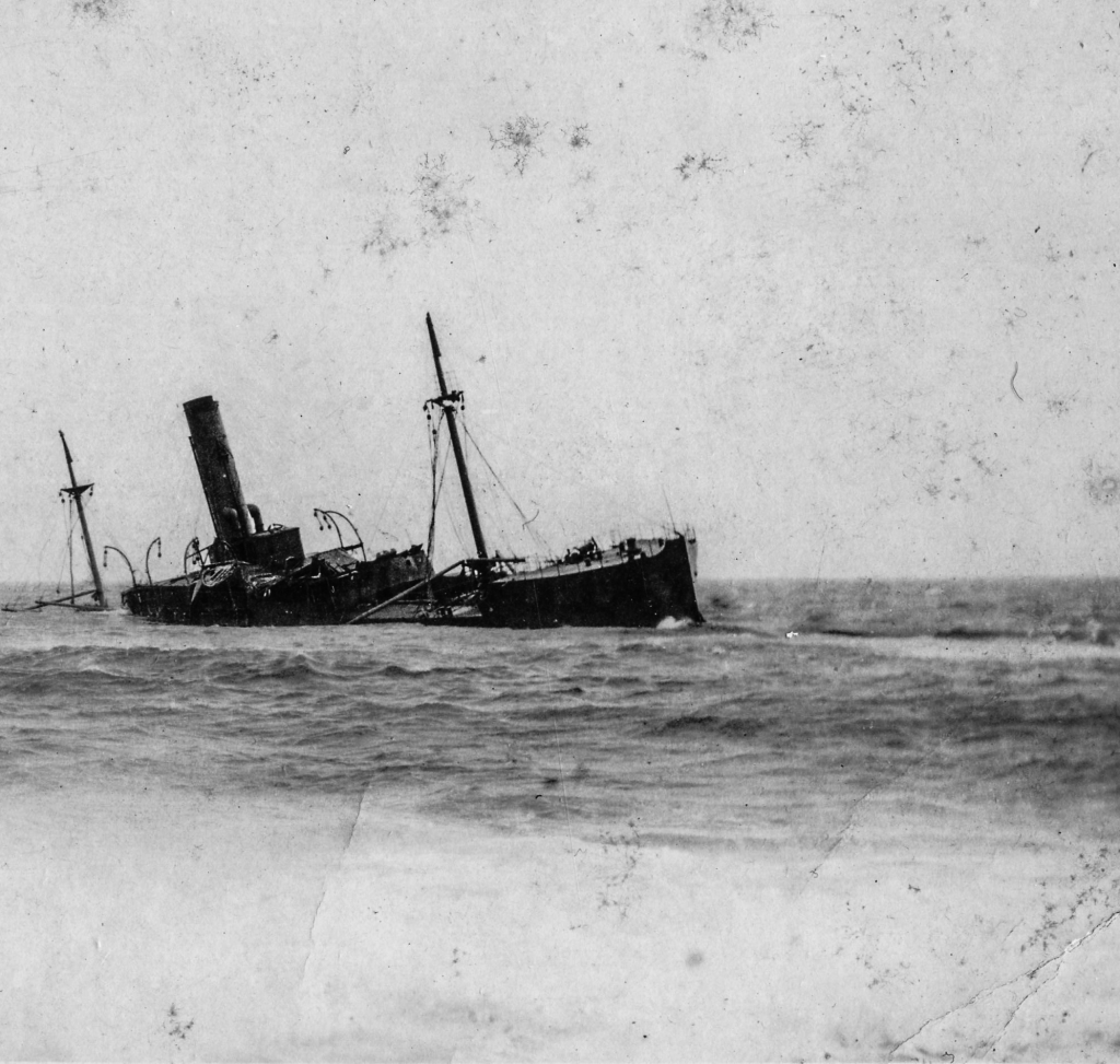 Black and white archival photograph of large passenger liner ship, the SS Florizel, run aground in ocean.