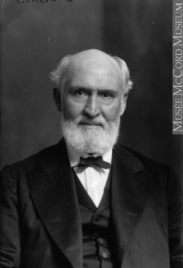 Head shot of an older bearded man wearing a tuxedo.