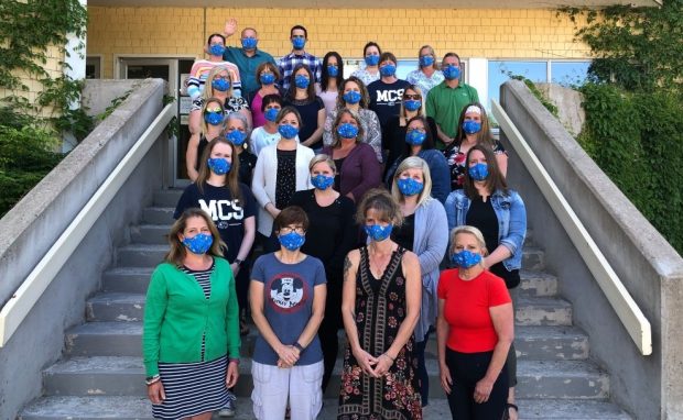 MCS staff group on the school steps wearing face masks.