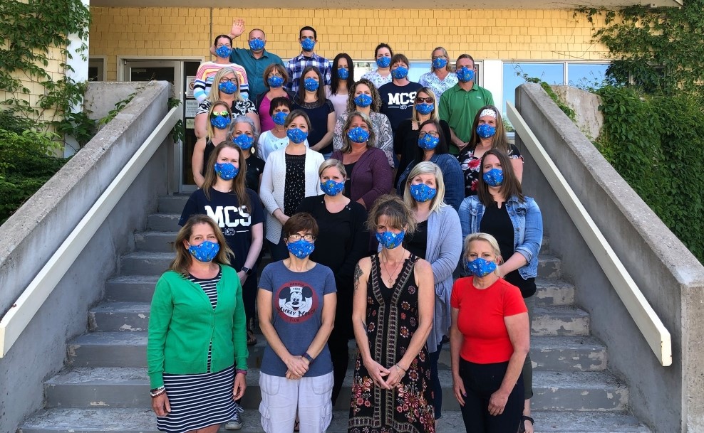 MCS staff group on the school steps wearing face masks.