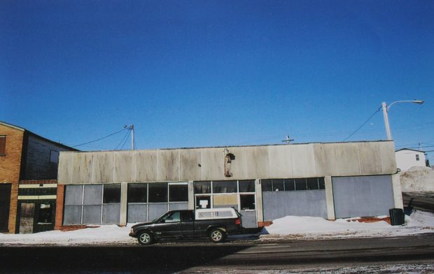 Colour photograph. Exterior view of Stewart’s shop. This building was constructed in the 1950s following a fire on Main Street, Windsor. A truck is parked in front of the building.