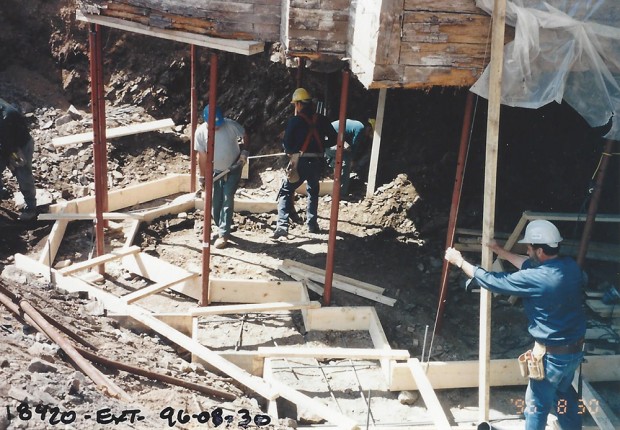 Colour photograph of workers preparing the formwork to cast the new foundations of the Manoir.