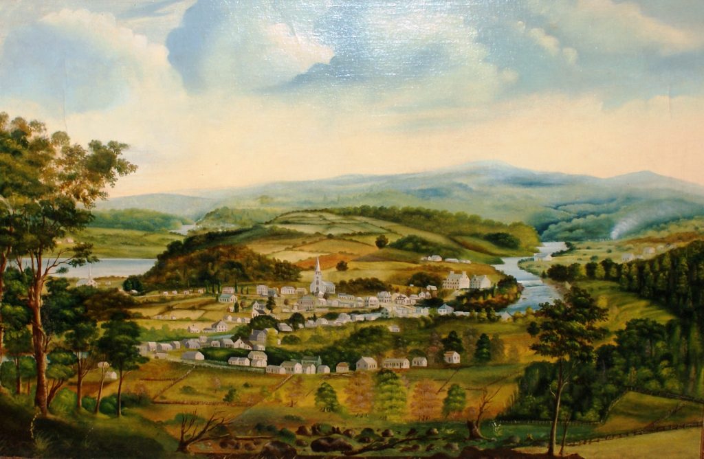 Oil landscape of the village of Saint-André-d’Argenteuil in summer; colour. The foreground shows deciduous and evergreen trees and green fields. Behind these, the village with its houses and white church is surrounded by two rivers on the left and right. A hill covered in green and ochre farmland rises behind the village. Indistinct blue hills can be seen in the distant background. The sky is cloudy, blue and white.