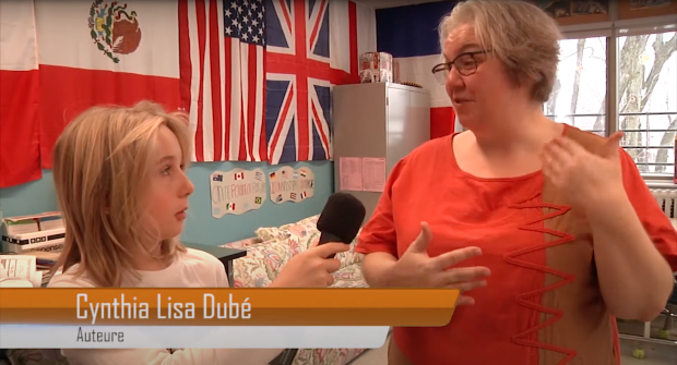 Student interviewing author Cynthia Lisa Dubé in a classroom.