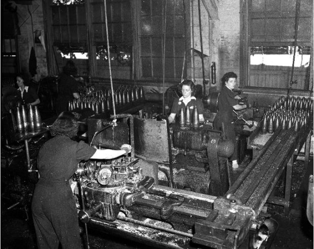 Photograph showing women working at machines in a munitions factory