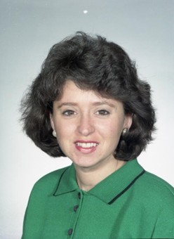Portrait of reporter Louise Plante. She is wearing a green top