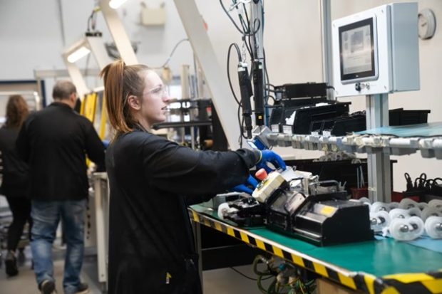 Colour photograph of a young woman working at BRP Megatech, a manufacturer based in the Mauricie.