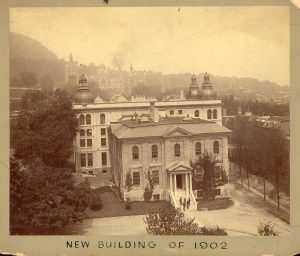 Sepia-toned image of a large stone Neo-Classical building.