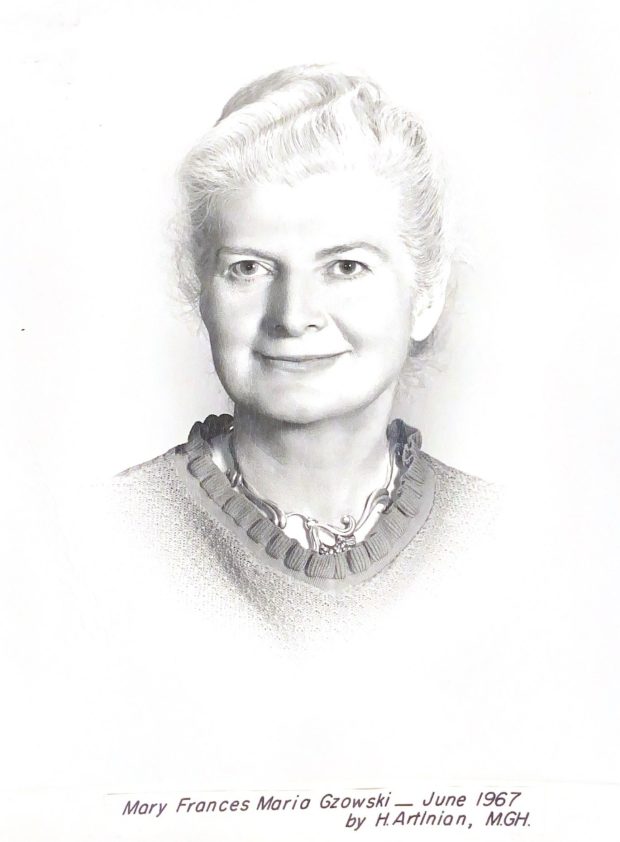 Black and white portrait of a woman wearing a sweater, a necklace and well coiffed white hair.