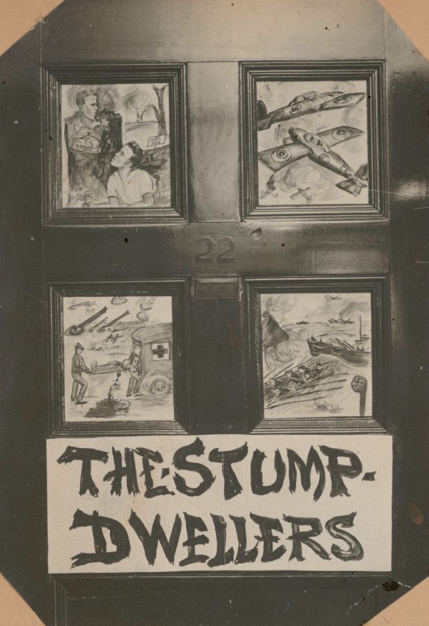 Black and white photo of a wooden door whose panels have been painted with various war scenes. Under the illustrations is written, The Stump Dwellers.