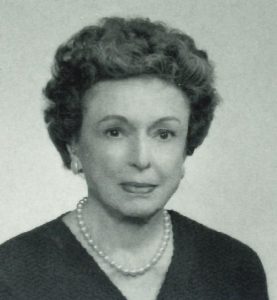 Black and white photo of Eleanor Sweezey wearing a pearl necklace.