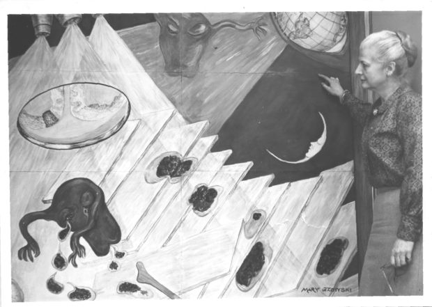 Black and white photo of Mary Gzowski gazing upon a mural depicting a caricature of a uterus flying through outer space.