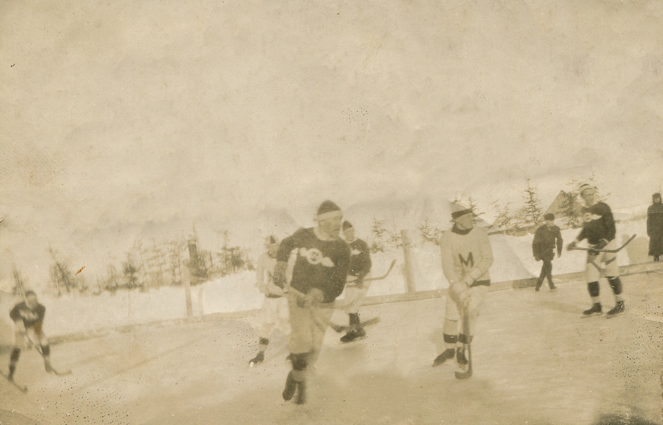 Sephia image of five young hockey players on an outdoor skating rink in Metis.