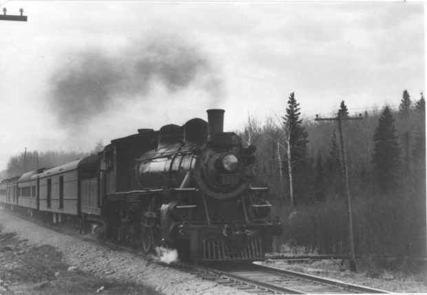Black and white photograph of a steam train on the T&NO Railway in Northeastern Ontario.