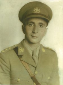 Colourized portrait photograph of Lieutenant Henry Koury dressed in uniform during WWII.