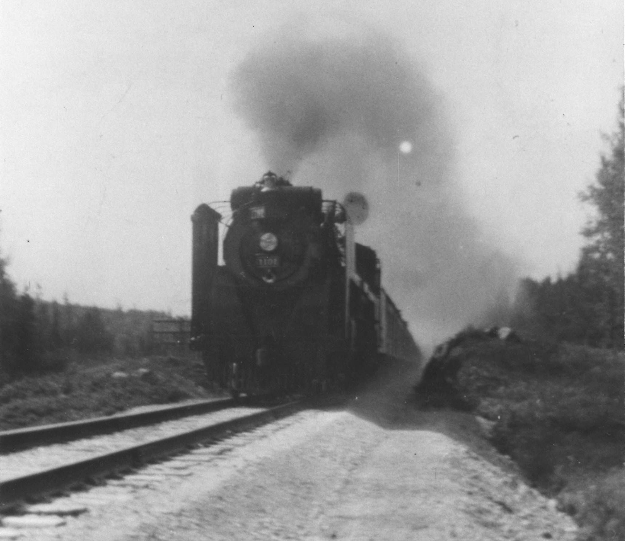Black and white photograph of a steam train on the T&NO Railway in Northeastern Ontario.