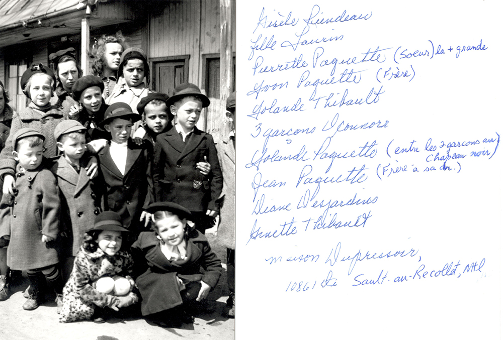 Portrait of a group of twelve children from various Sault-au-Récollet families gathered in front of 10865 Du Pressoir Street. They are all wearing coats and jackets. Except for the tallest girl, they are all wearing a cap or hat.