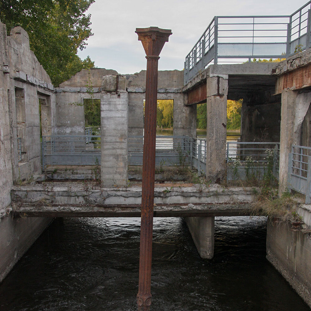 A lonely cast-iron column still stands amidst the ruins.