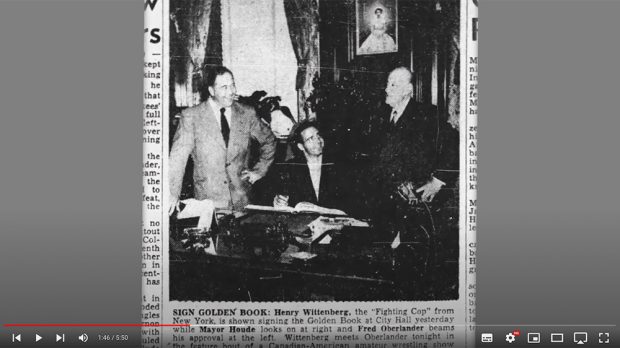 Newspaper clipping from The Gazette: Mr. Oberlander and another wrestler sign the City of Montréal’s Golden Book.
