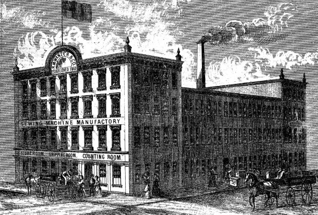 An illustration of R. M. Wanzer's three-storey factory with two four-storey buildings at each end. It takes up an entire city block and there is a flag at the front of the building and a tall chimney in the centre. People walk in front of the building and horse-drawn carriages drive past.