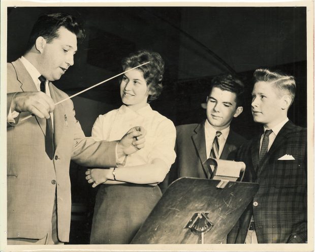 Leonard Pearlman demonstrates conducting to 3 students