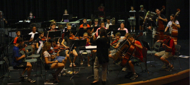 Summer Music Camp orchestra on stage