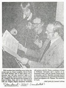 Stuart Laughton, Steven Pettes, and David Marsden look over music