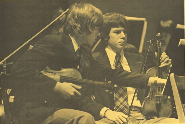 Two students of the Symphony House Music School look at music