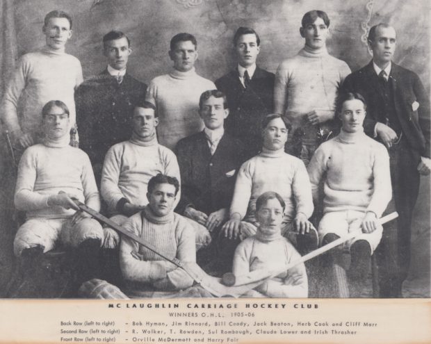 Black and white image of nine hockey players and four coaches in formal wear. Seven of the men are posed sitting, with the other six standing. Title: MCLAUGHLIN CARRIAGE HOCKEY CLUB WINNERS O.H.L. 1905-1906