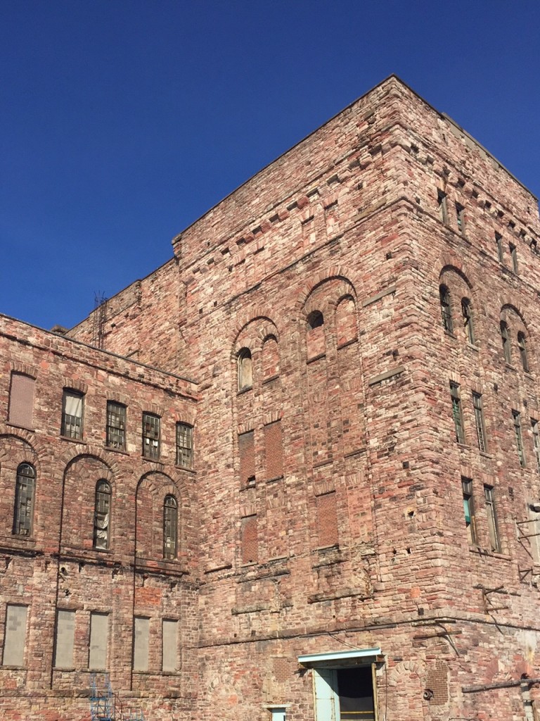 Blue sky in the background, sandstone building tower.