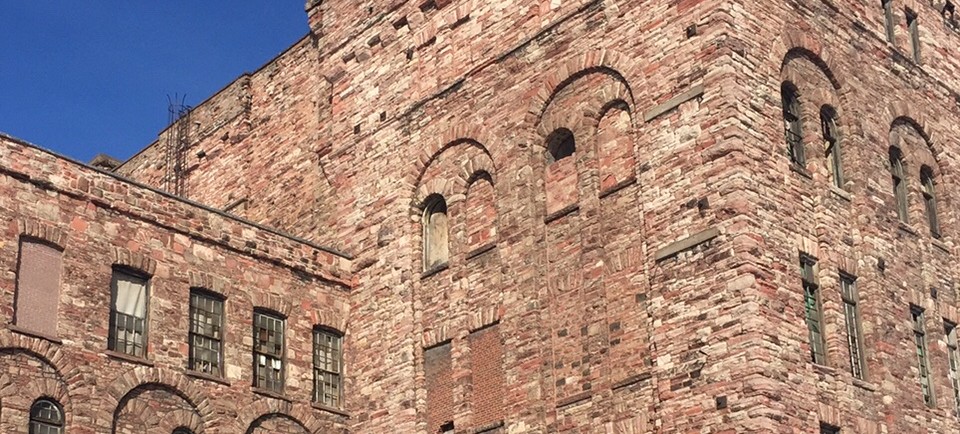 Blue sky in the background, sandstone building tower.