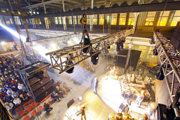 People sitting watching a concert. Birds eye view from behind the stage.